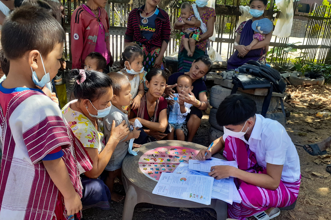 Mothers and young children in Kayin (Karen) State, Myanmar, gather to receive humanitarian assistance.