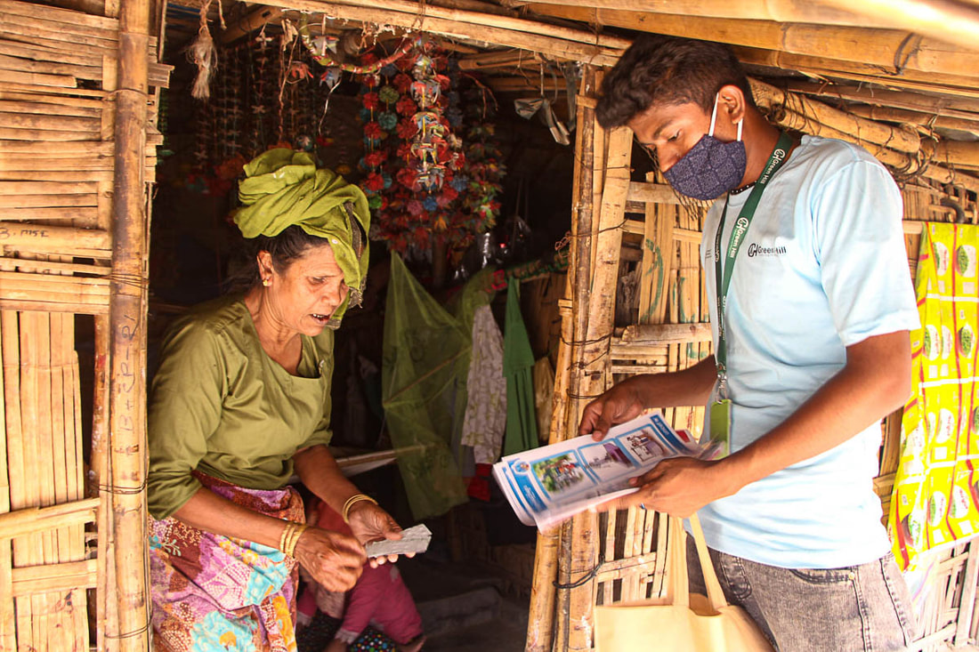 A CPI-supported WASH volunteer distributes water purification tablets and water safety information in Kutupalong Refugee Camp, Cox's Bazar, Bangladesh.