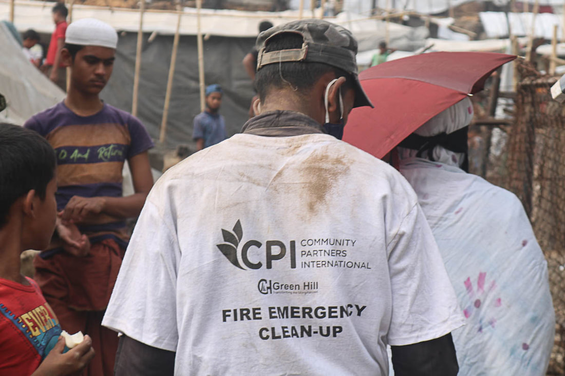 A Rohingya volunteer supported by CPI participates in fire debris clearing in Kutuplaong Refugee Camp, Cox's Bazar, Bangladesh.