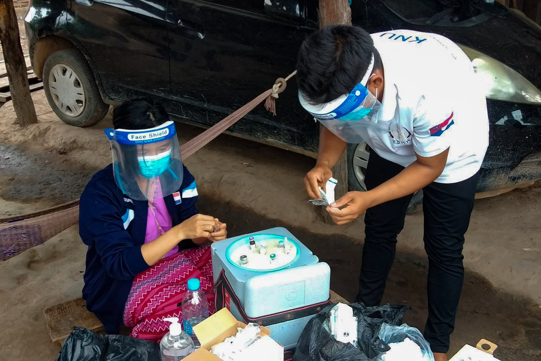 Ethnic health organization health workers prepare vaccines for transport to remote communities in southeast Myanmar. 