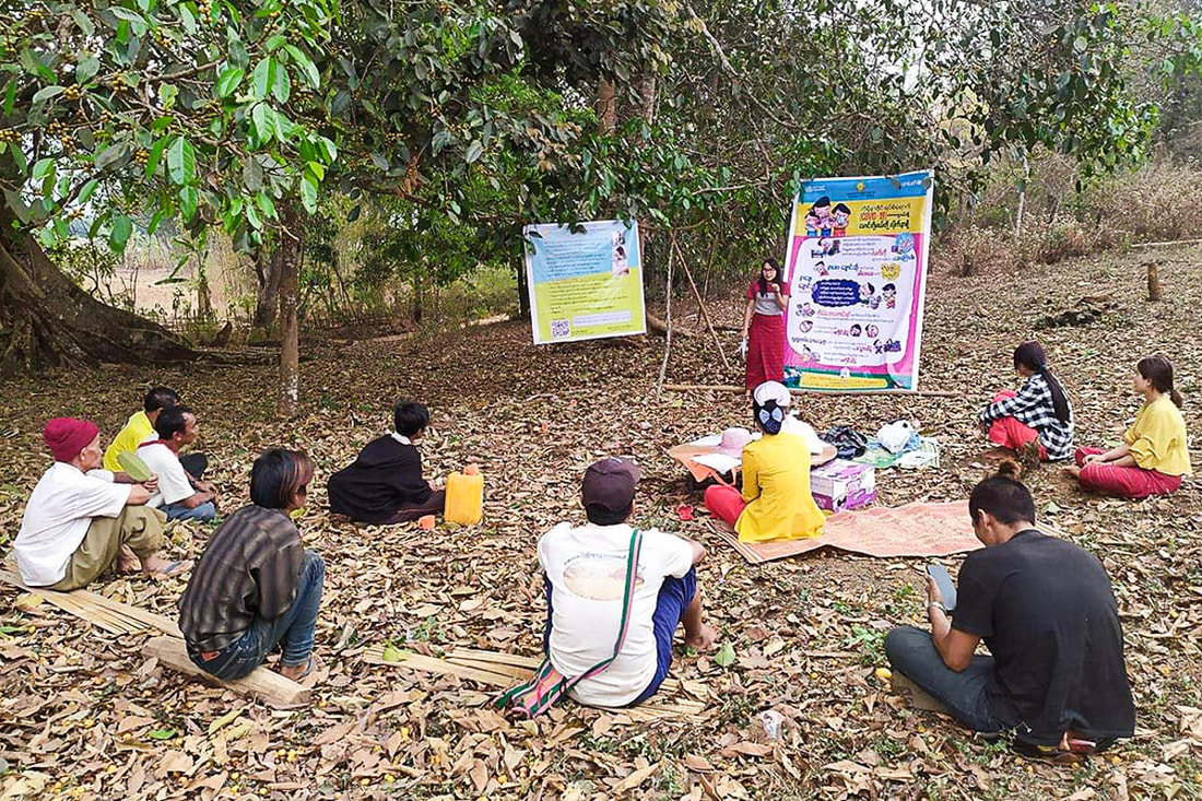 A health worker from the Ta'ang Health Committee educates community members on COVID-19 prevention and response in Shan State, Myanmar.