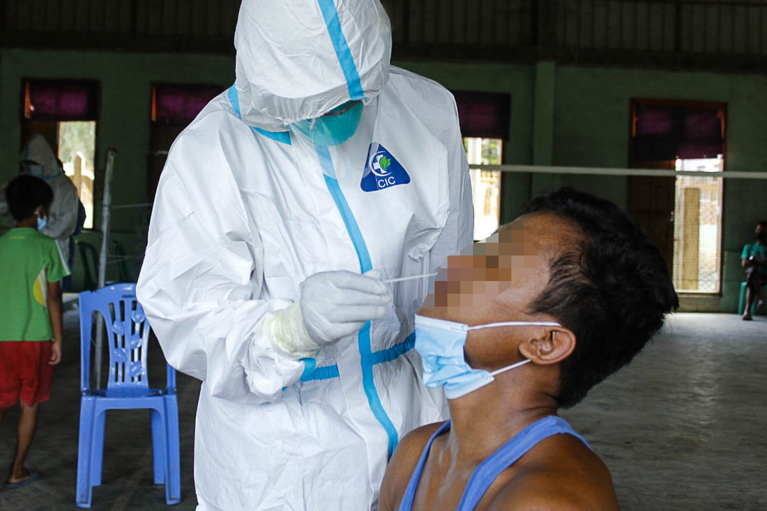 A health worker conducts a COVID-19 test in Chin State, Myanmar.