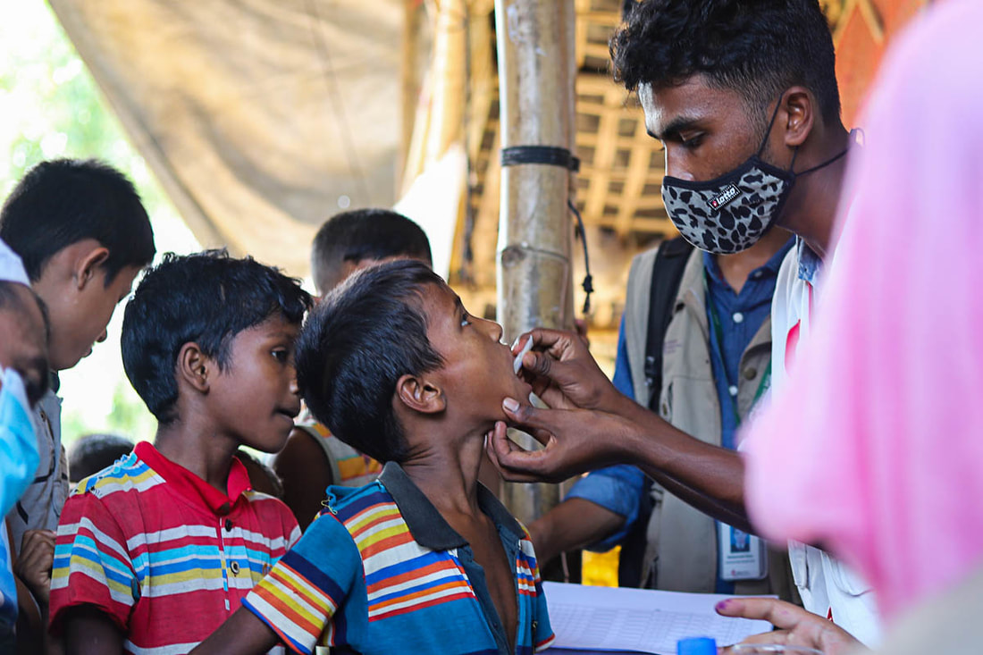 A health worker administers the cholera vaccine to a child in Kutupalong Refugee Camp, Cox's Bazar, Bangladesh.