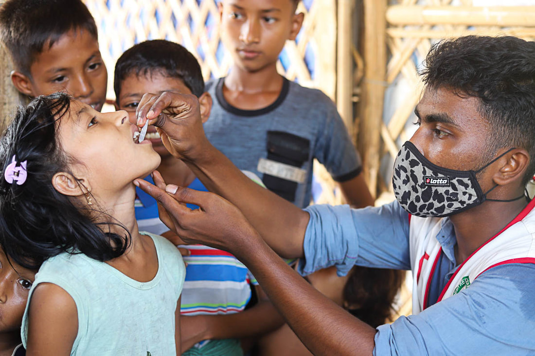 A health worker administers the cholera vaccine to a child in Kutupalong Refugee Camp, Cox's Bazar, Bangladesh.
