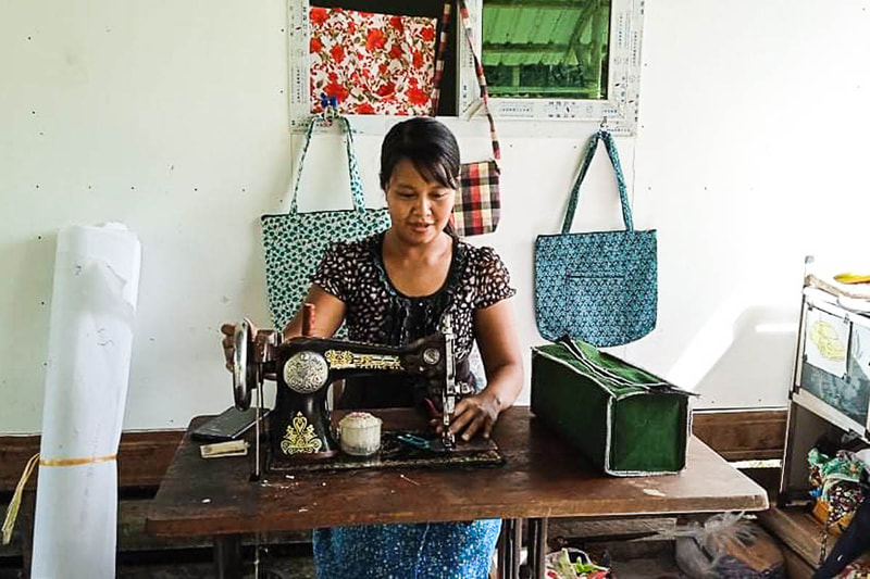 Eindray, 28, uses the sewing machine lent to her by Precious Lady in Rakhine State, Myanmar.
