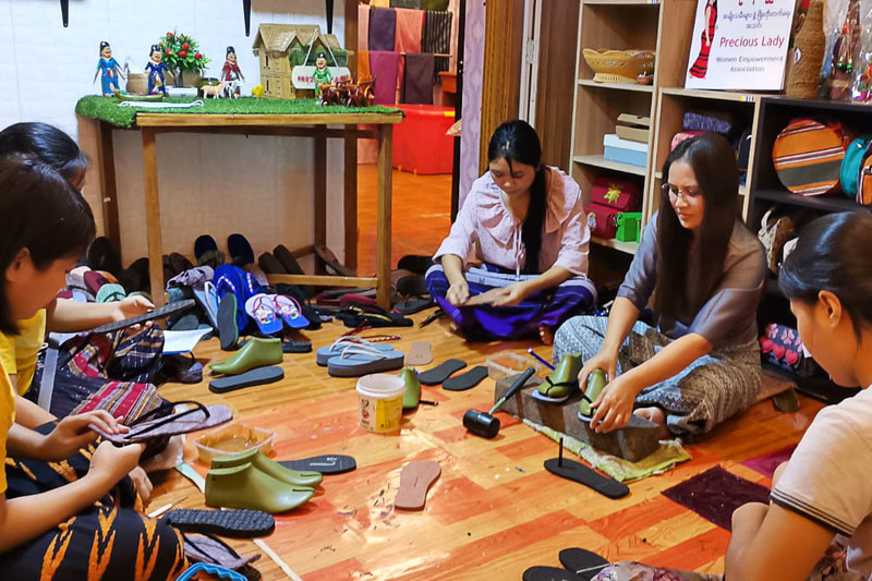 Kyi San Lwin teaches women how to make traditional Myanmar slippers during a craft workshop organized by Previous Lady in Rakhine State, Myanmar. 
