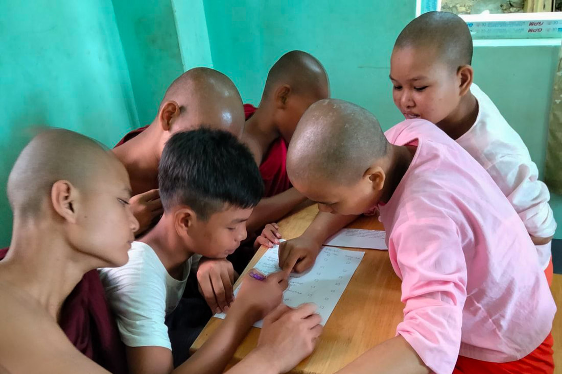 Children participate in a classroom activity at Phaung Daw Oo Monastic School in Mandalay, Myanmar.