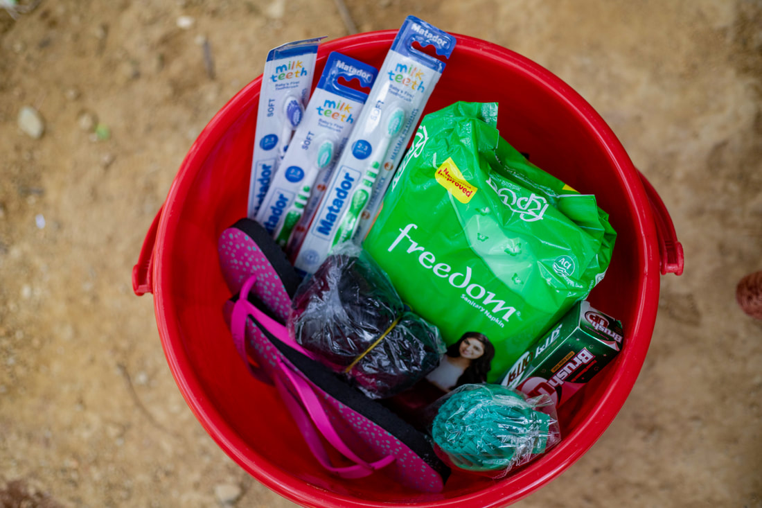 A hygiene kit provided by Community Partners International to Rohingya women in Kutupalong Refugee Camp, Bangladesh, containing sanitary pads, toothbrushes, toothpaste, sandals and other supplies..