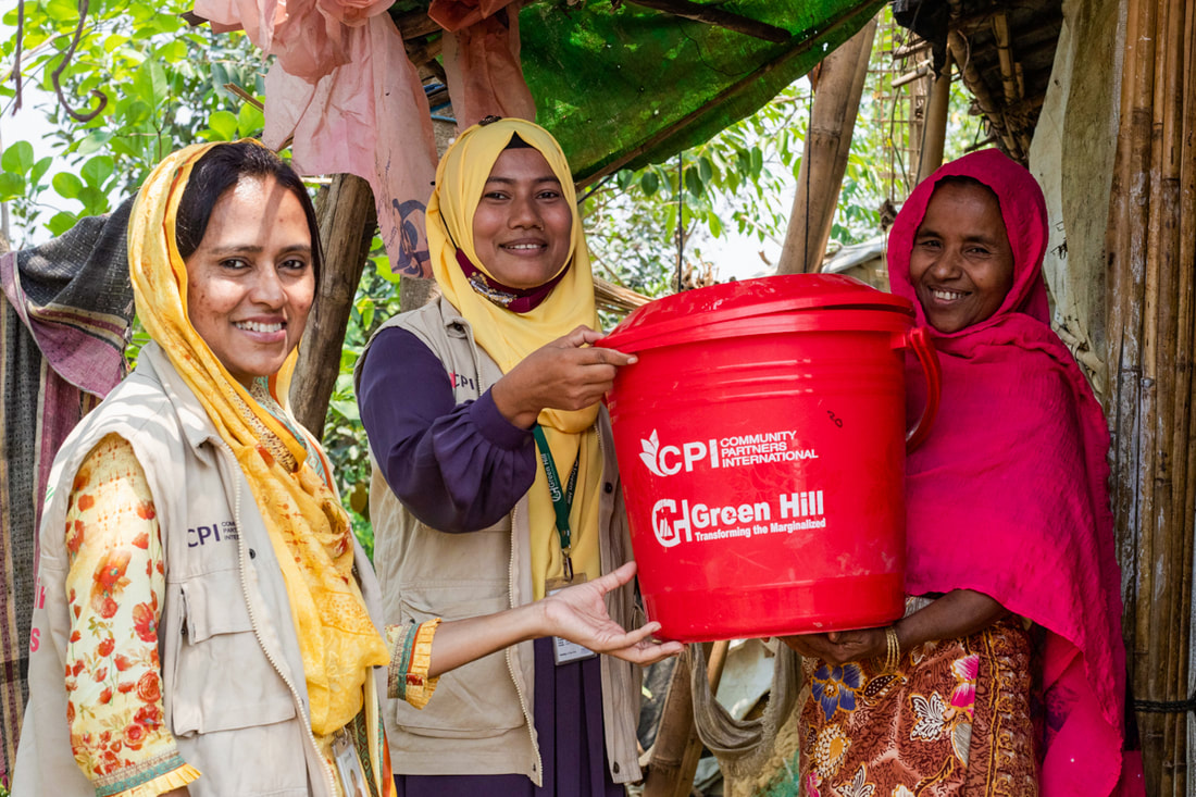 Naznin (left) and Sweety (center) visit a woman in Kutupalong Refugee Camp, Bangladesh, to provide hygiene supplies. 