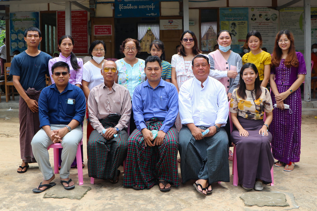 Project Manager Saw Jackson (seated second from right) with YMCA colleagues at the organization's Yay Sin clinic in Nay Pyi Taw, Myanmar.