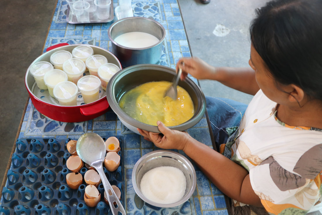 A YMCA staff member prepares egg pudding for sale in Nay Pyi Taw, Myanmar. 