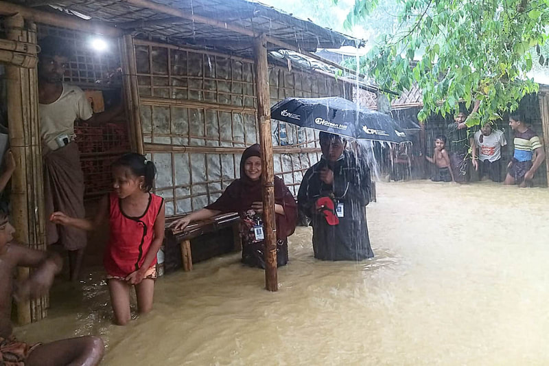 Rohingya volunteers provide emergency assistance to fellow refugees during flooding in Kutupalong Refugee Camp, Bangladesh.