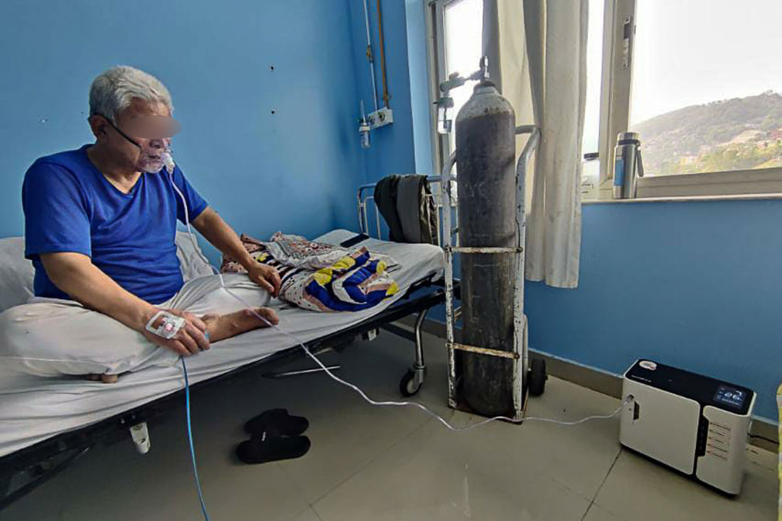 Pramita's father uses an oxygen concentrator supplied by Community Partners International at Dhulikhel Hospital in Nepal.