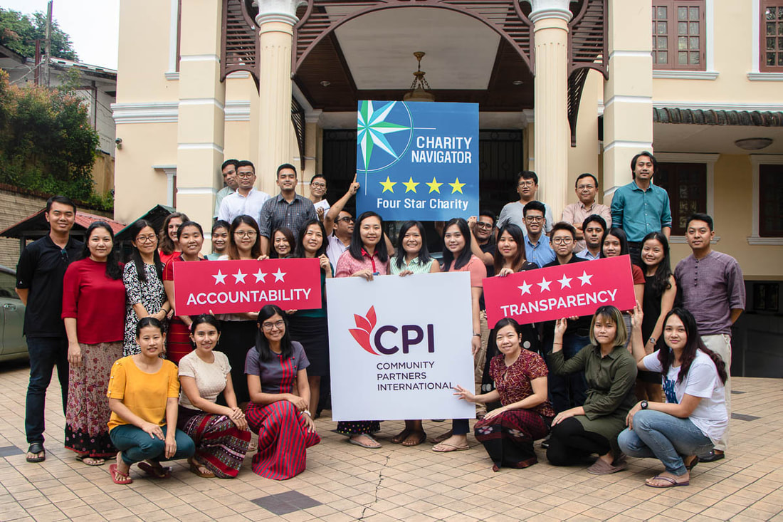 Members of Community Partners International's team in Myanmar celebrate the organization's Charity Navigator 4-Star rating.