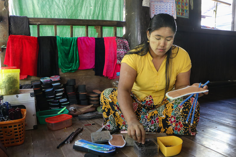 May uses the skills she learned to make sandals at her home in Rakhine State, Myanmar.