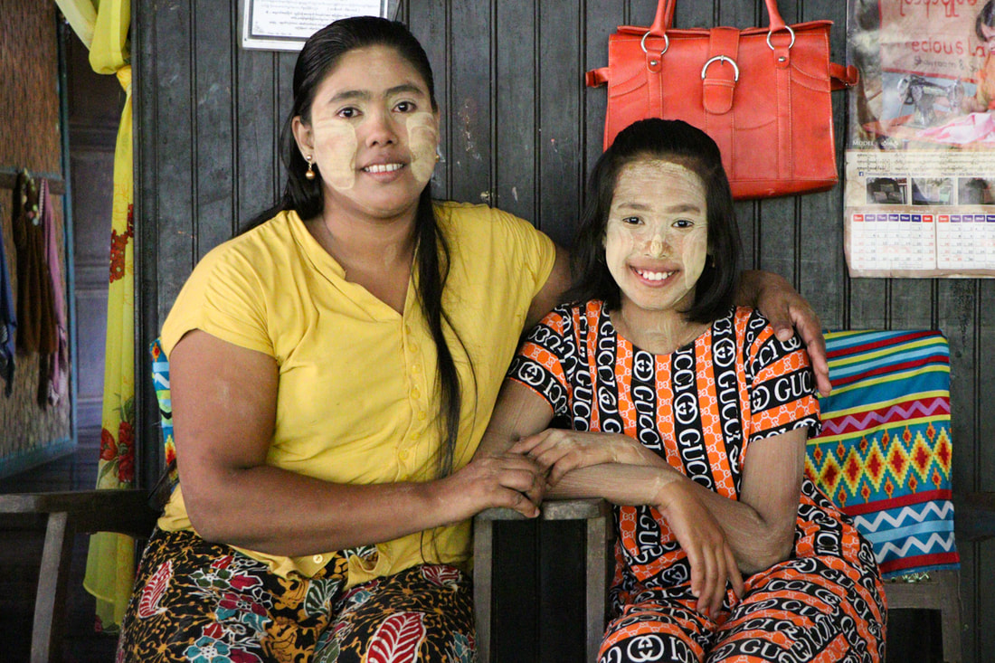 May (left), a widow in Rakhine State, Myanmar, has learned sandal-making skills that help her to earn income and support her daughter (right).