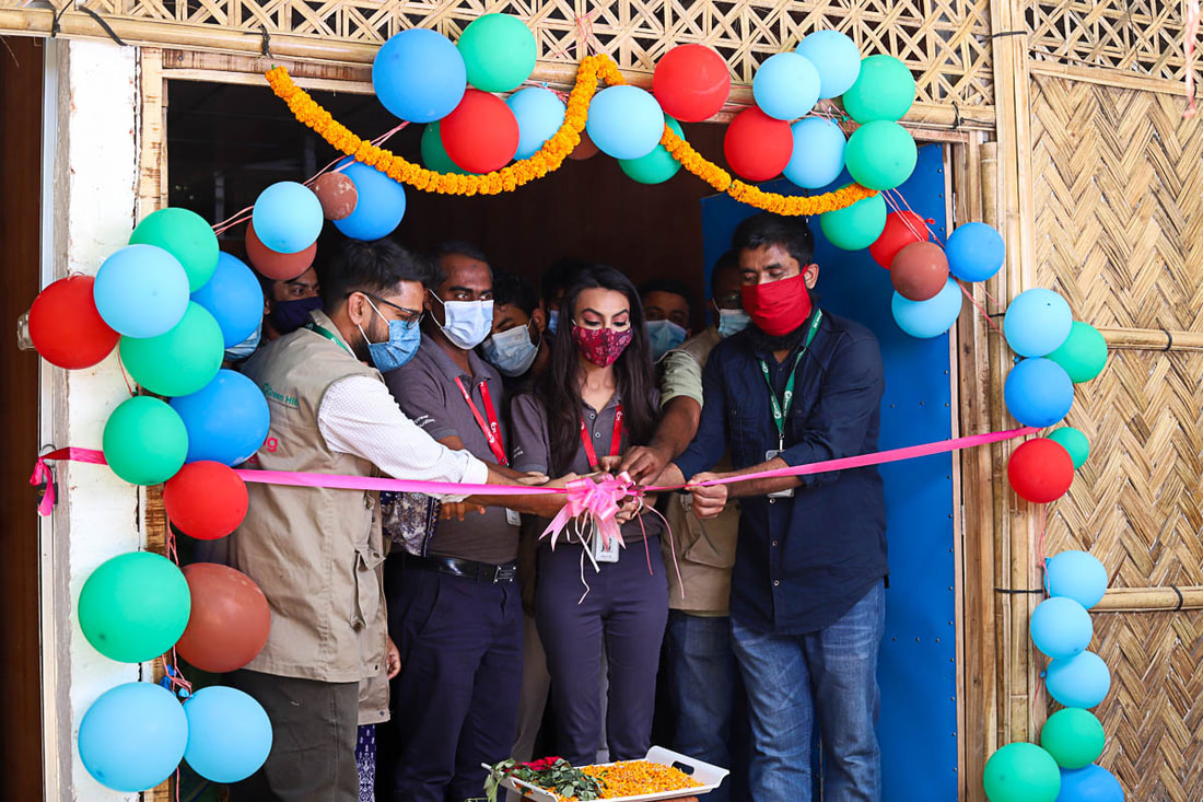 Anam Ali, CPI's Country Director in Bangladesh, cuts the ribbon at the opening ceremony for the new health post supported by CPI in Camp 1W of Kutupalong Refugee Camp, Cox's Bazar, Bangladesh.