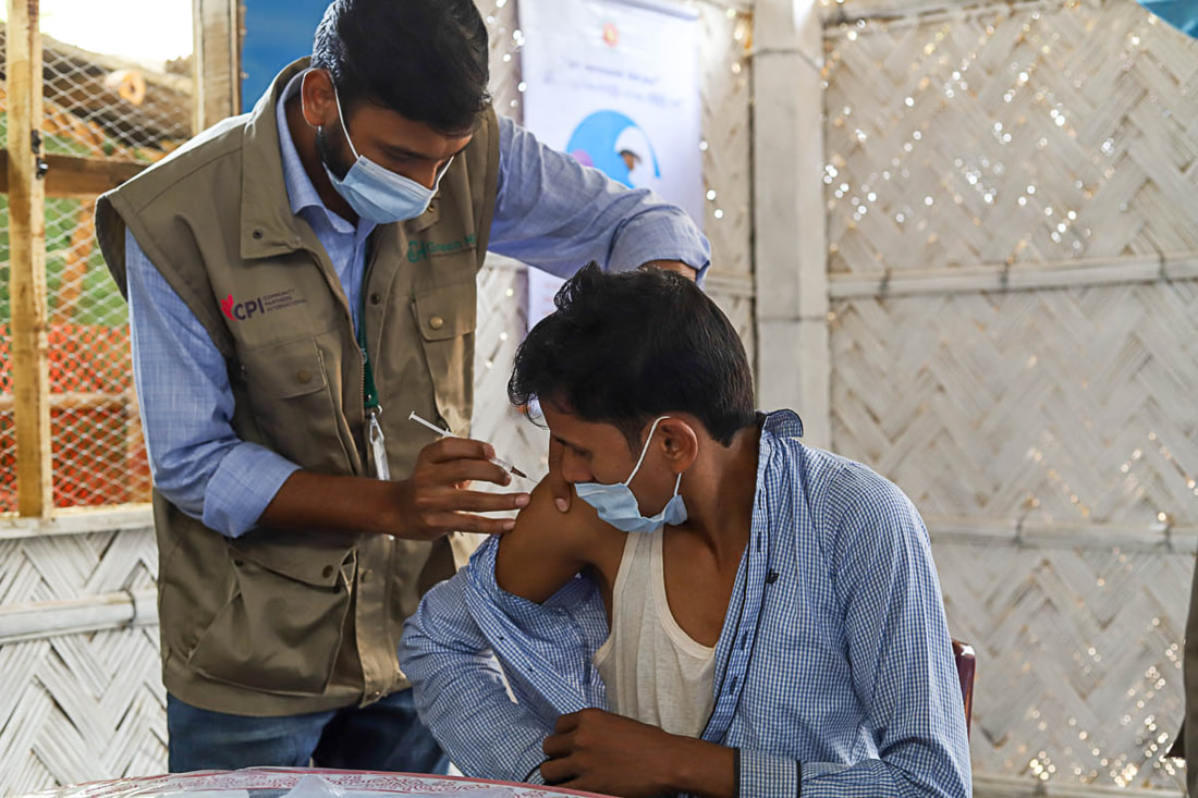 A community member receives the COVID-19 vaccine at the new health post supported by CPI  in Camp 1W of Kutupalong Refugee Camp, Cox's Bazar, Bangladesh.