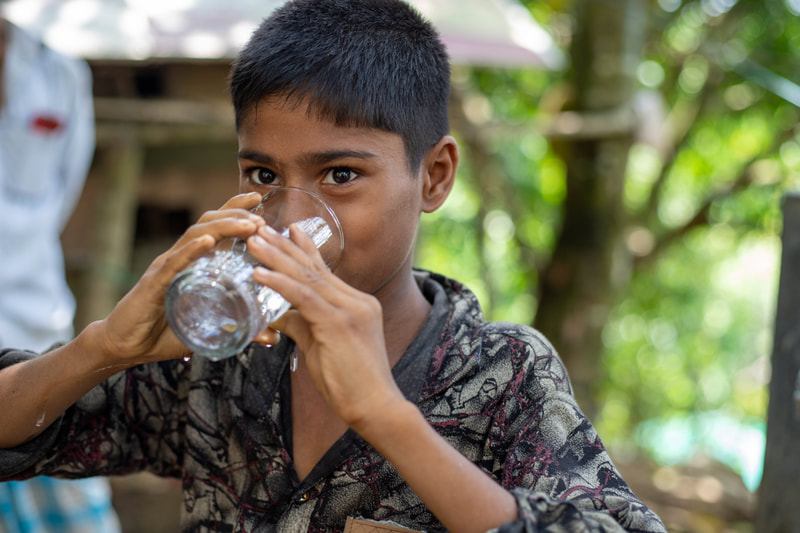 A boy drinks water from a tapstand that forms part of the CPI-supported water network in Doria Nagar village, Cox's Bazar, Bangladesh.