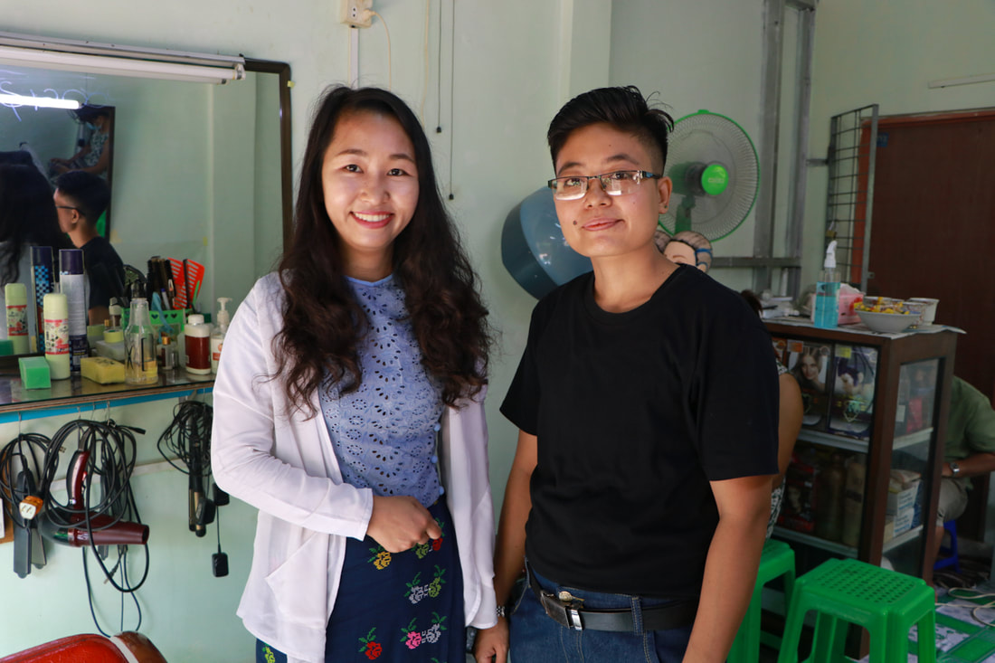 MDCDA Project Manager Wai Wai Aung (left) with Ko Moe at his hair salon in Insein Township, Yangon, Myanmar.
