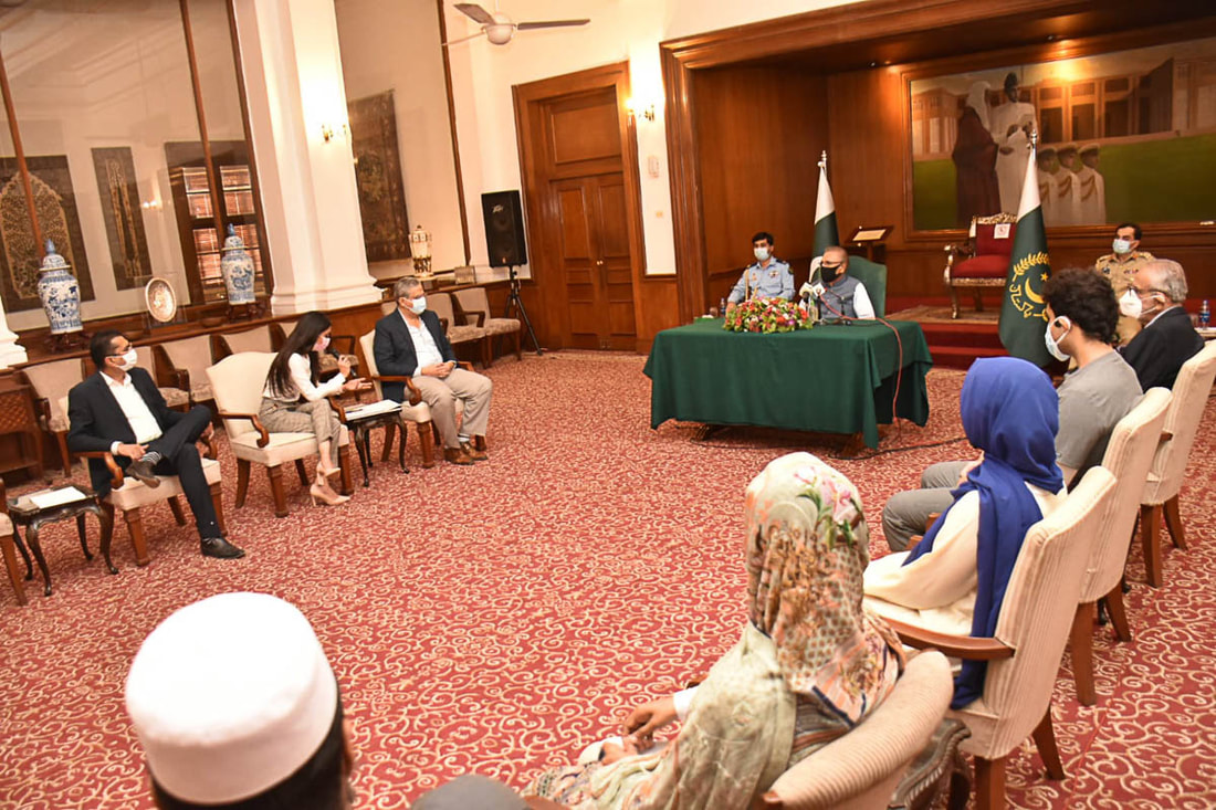 President Dr. Arif Alvi (seated at desk) meets with representatives of Community Partners International, SHINE Humanity and the Patients' Aid Foundation in Karachi, Pakistan, on August 30, 2021.
