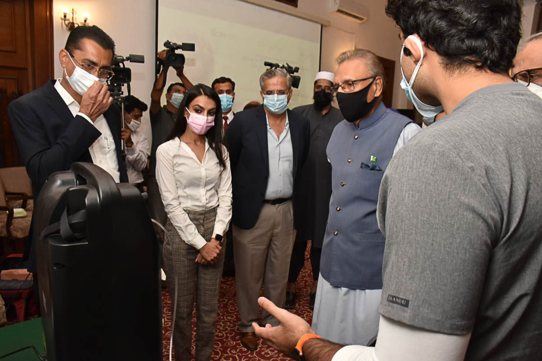 President Dr. Arif Alvi (fourth from left) inspects an oxygen concentrator donated by Community Partners International in Karachi, Pakistan, on August 30, 2021.