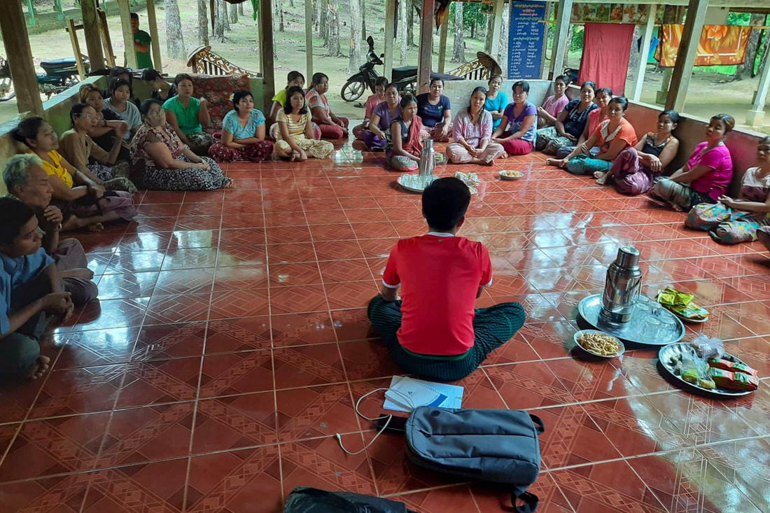 Community members in southeast Myanmar participate in a malaria prevention education session led by a health worker from the Mon National Health Committee. 